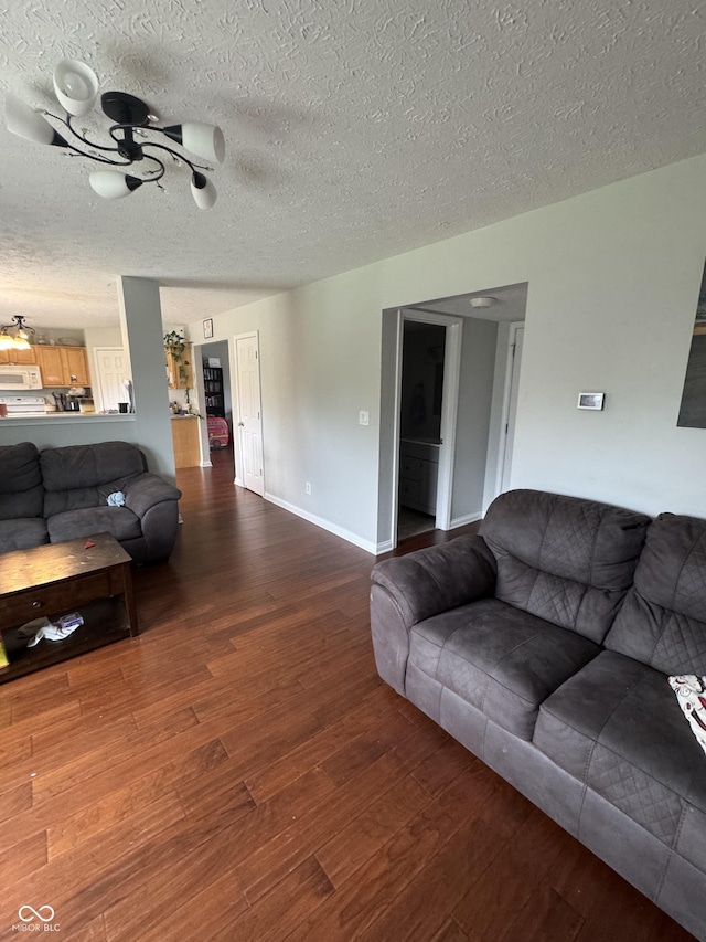 6027 Moonseed Cir, Indianapolis, IN 46203 - living room with wood finished floors, a ceiling fan, and a textured ceiling