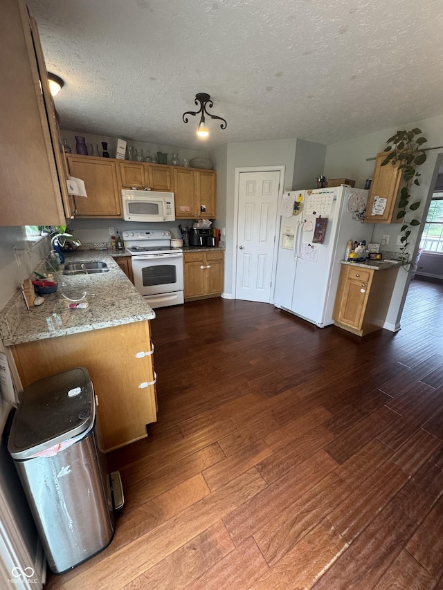 6027 Moonseed Cir, Indianapolis, IN 46203 - kitchen featuring white appliances, dark wood-type flooring, a textured ceiling, brown cabinets, and light stone countertops