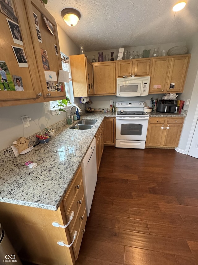 6027 Moonseed Cir, Indianapolis, IN 46203 - kitchen featuring white appliances, dark wood finished floors, a textured ceiling, light stone counters, and brown cabinetry