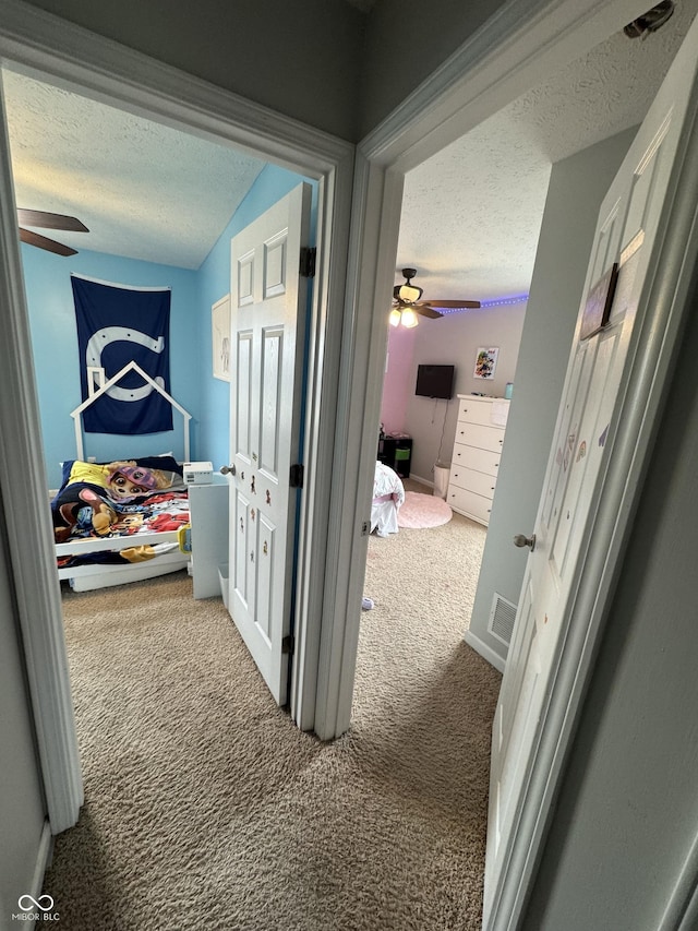 6027 Moonseed Cir, Indianapolis, IN 46203 - hall featuring a textured ceiling and carpet flooring