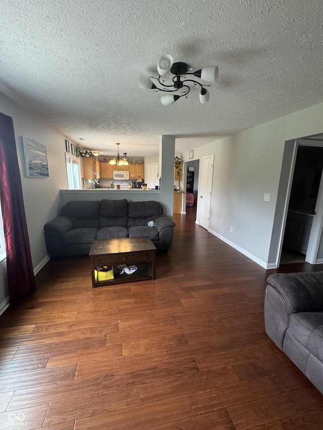 6027 Moonseed Cir, Indianapolis, IN 46203 - living area with wood finished floors, a ceiling fan, and a textured ceiling