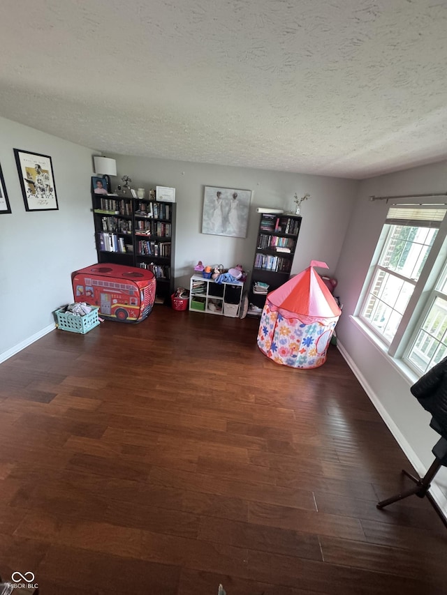 6027 Moonseed Cir, Indianapolis, IN 46203 - recreation room featuring a textured ceiling and wood finished floors