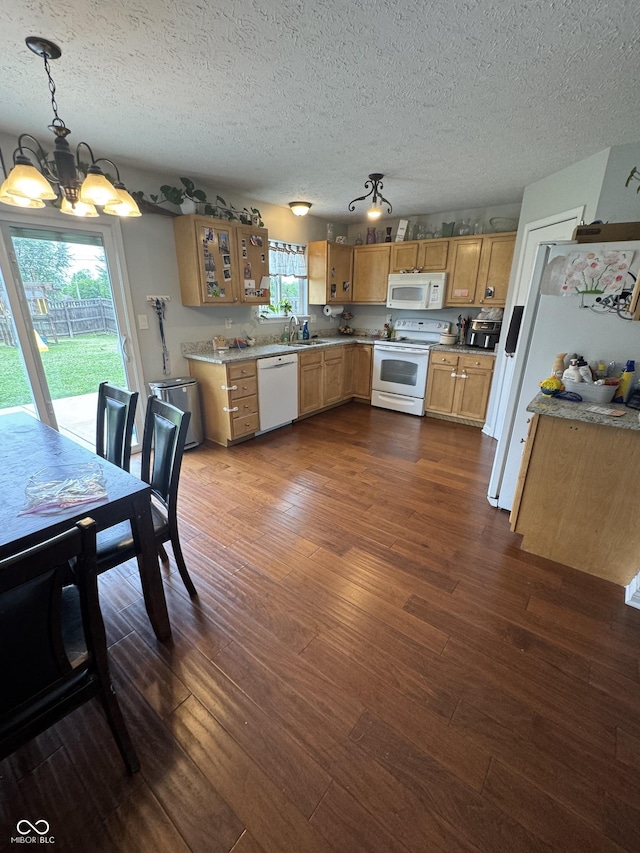 6027 Moonseed Cir, Indianapolis, IN 46203 - kitchen featuring white appliances, a chandelier, dark wood-style flooring, a textured ceiling, and light countertops