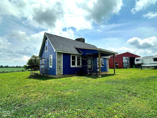 1842 S 850 E, Crawfordsville, IN 47933 - back of property with a yard, a chimney, stone siding, and a shingled roof