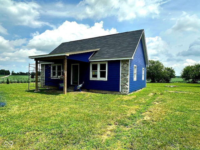 1842 S 850 E, Crawfordsville, IN 47933 - view of front of home featuring a front yard, stone siding, and a shingled roof