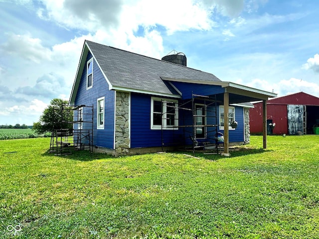 1842 S 850 E, Crawfordsville, IN 47933 - back of property featuring a lawn, a chimney, roof with shingles, and stone siding