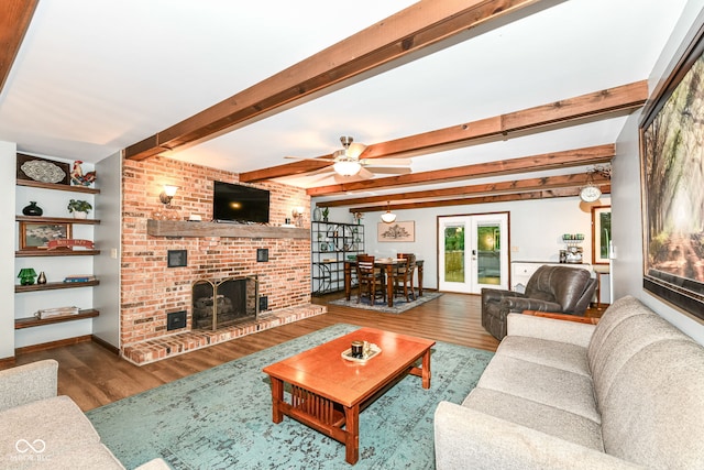 1624 Riley Rd, Lebanon, IN 46052 - living room with wood finished floors, a fireplace, a ceiling fan, beamed ceiling, and french doors