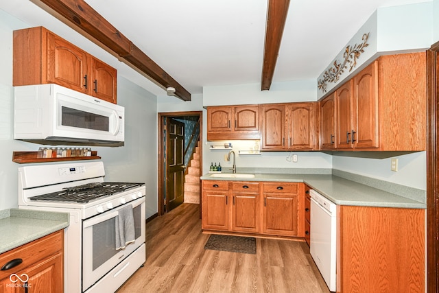 1624 Riley Rd, Lebanon, IN 46052 - kitchen featuring white appliances, beamed ceiling, light wood-style floors, light countertops, and brown cabinetry