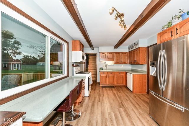 1624 Riley Rd, Lebanon, IN 46052 - kitchen featuring white appliances, light wood finished floors, beam ceiling, brown cabinets, and light countertops