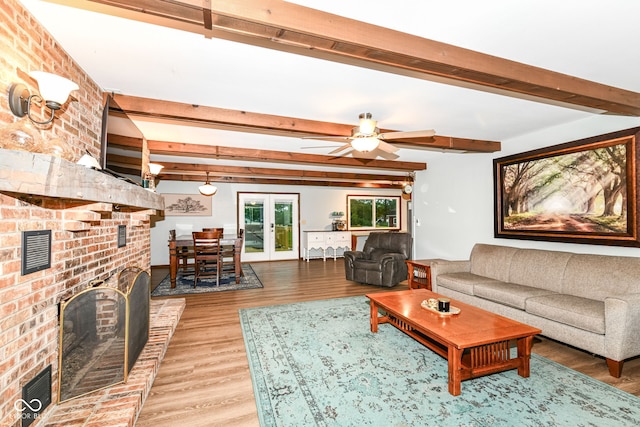 1624 Riley Rd, Lebanon, IN 46052 - living room featuring wood finished floors, beam ceiling, ceiling fan, a fireplace, and french doors