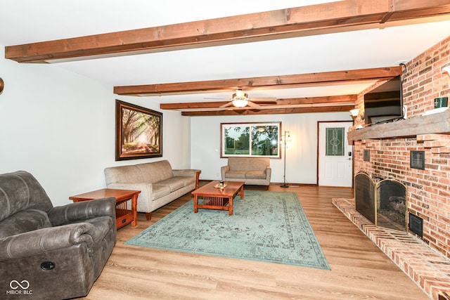 1624 Riley Rd, Lebanon, IN 46052 - living area with a brick fireplace, wood finished floors, beam ceiling, and ceiling fan
