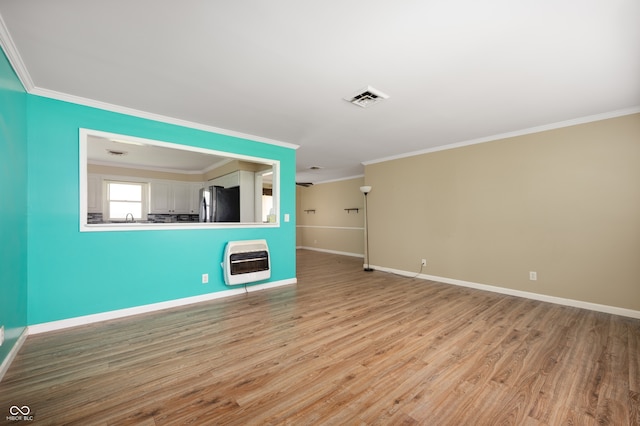 10500 S County Road 200 W, Muncie, IN 47302 - unfurnished living room with heating unit, ornamental molding, and wood finished floors