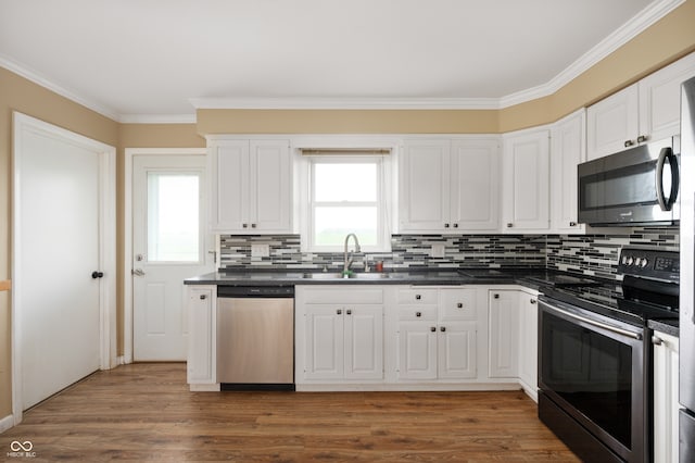 10500 S County Road 200 W, Muncie, IN 47302 - kitchen with stainless steel appliances, dark countertops, crown molding, tasteful backsplash, and white cabinets