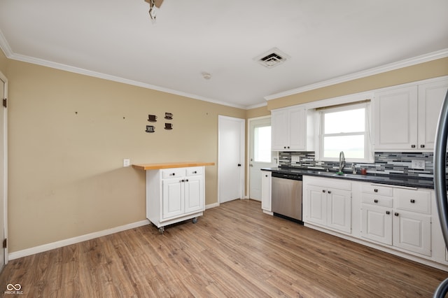 10500 S County Road 200 W, Muncie, IN 47302 - kitchen with stainless steel dishwasher, ornamental molding, light wood finished floors, white cabinetry, and backsplash