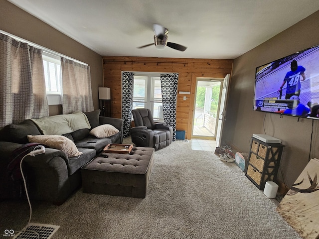 2824 Brown St, Anderson, IN 46016 - living area featuring ceiling fan, wood walls, and carpet