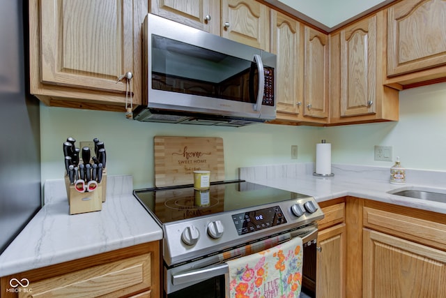 7911 Bentley Commons Dr, Indianapolis, IN 46259 - kitchen with stainless steel appliances, light countertops, and light brown cabinetry