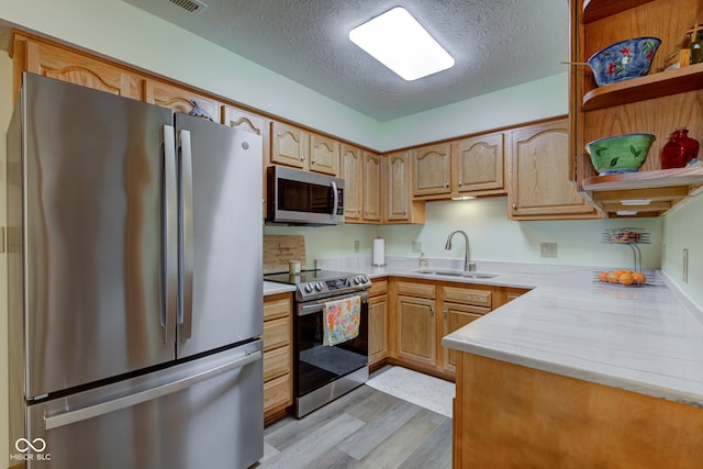 7911 Bentley Commons Dr, Indianapolis, IN 46259 - kitchen with stainless steel appliances, light wood-style floors, light countertops, open shelves, and a textured ceiling