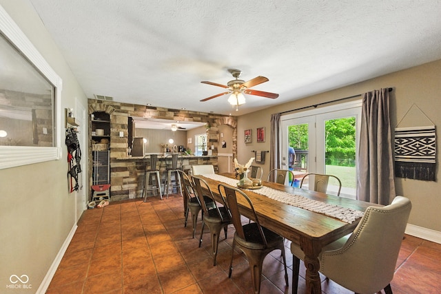 9265 Brunson Run, Indianapolis, IN 46256 - dining area featuring a ceiling fan, dark tile patterned flooring, and a textured ceiling