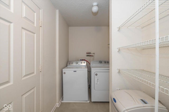 14523 Lee Stewart Ln, Fishers, IN 46038 - laundry area featuring washing machine and dryer and a textured ceiling