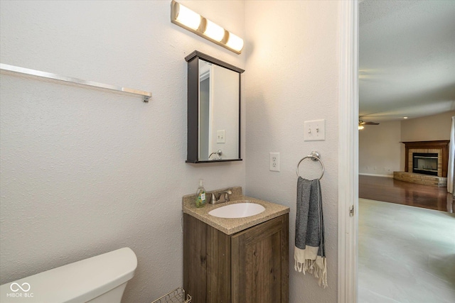 14523 Lee Stewart Ln, Fishers, IN 46038 - half bathroom featuring vanity, a fireplace, and a ceiling fan