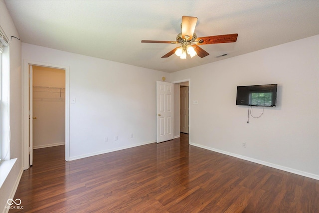 14523 Lee Stewart Ln, Fishers, IN 46038 - unfurnished bedroom with dark wood-type flooring, a spacious closet, and ceiling fan