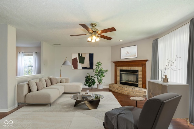 14523 Lee Stewart Ln, Fishers, IN 46038 - living room featuring a brick fireplace, ceiling fan, and wood finished floors