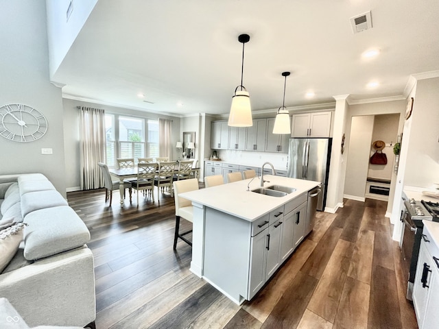 4281 Viewforth Ln, Bargersville, IN 46106 - kitchen featuring appliances with stainless steel finishes, ornamental molding, open floor plan, an island with sink, and light countertops