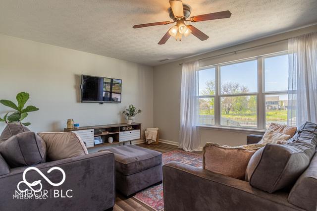 12584 Cold Stream Rd, Noblesville, IN 46060 - living room with wood finished floors, a textured ceiling, and a ceiling fan