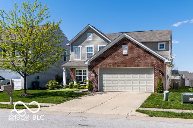 12584 Cold Stream Rd, Noblesville, IN 46060 - traditional-style home with brick siding, driveway, a front lawn, and an attached garage