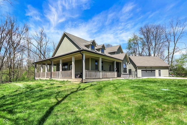 5386 W 1100, Fountaintown, IN 46130 - farmhouse-style home with covered porch, board and batten siding, a garage, and a front yard