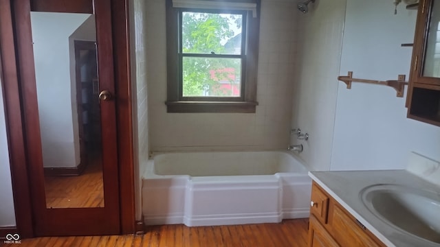 8955 N County Road 925 E, Seymour, IN 47274 - bathroom featuring vanity, wood finished floors, and shower / tub combination