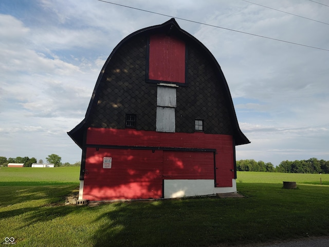 8955 N County Road 925 E, Seymour, IN 47274 - view of property exterior with a barn, a detached garage, a lawn, and an outdoor structure