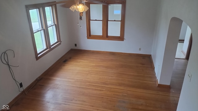 8955 N County Road 925 E, Seymour, IN 47274 - empty room featuring arched walkways, wood finished floors, and a ceiling fan