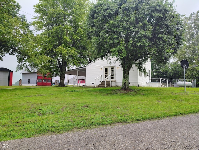 8955 N County Road 925 E, Seymour, IN 47274 - view of green lawn with entry steps and a carport
