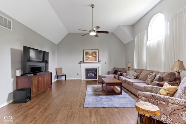 13624 Alston Dr, Fishers, IN 46037 - living area with a fireplace, ceiling fan, wood finished floors, and high vaulted ceiling