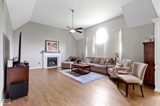 13624 Alston Dr, Fishers, IN 46037 - living area featuring a fireplace, ceiling fan, wood finished floors, and lofted ceiling
