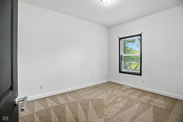 3210 Hovey St, Indianapolis, IN 46218 - carpeted empty room featuring baseboards