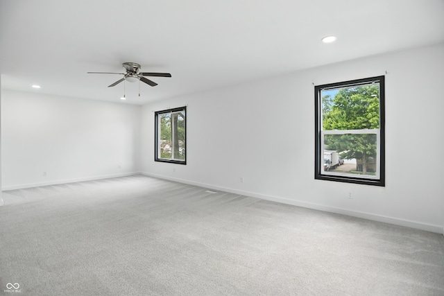 3210 Hovey St, Indianapolis, IN 46218 - spare room featuring healthy amount of natural light, recessed lighting, light carpet, and a ceiling fan