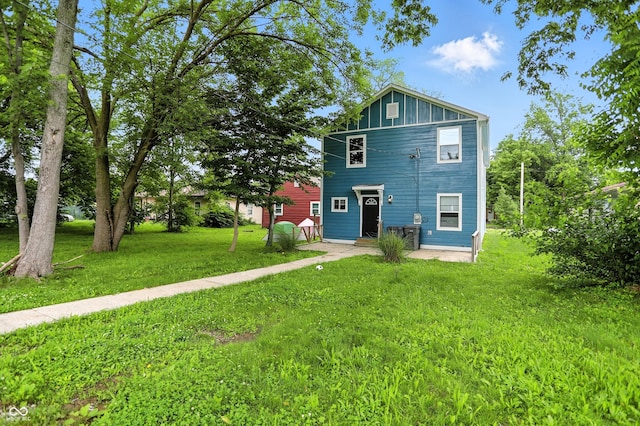 3210 Hovey St, Indianapolis, IN 46218 - rear view of house featuring a lawn and board and batten siding
