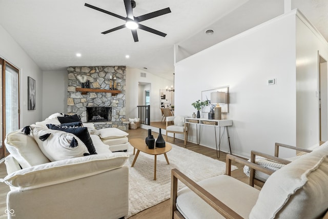 5982 Oak Hill E Dr, Plainfield, IN 46168 - living area featuring a ceiling fan, wood finished floors, vaulted ceiling, a chandelier, and a fireplace