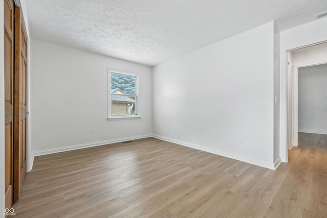 5982 Oak Hill E Dr, Plainfield, IN 46168 - unfurnished room with light wood-style floors and a textured ceiling