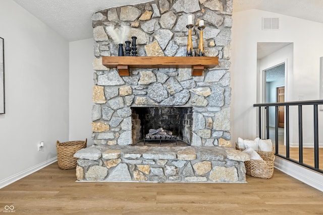 5982 Oak Hill E Dr, Plainfield, IN 46168 - detailed view of wood finished floors, a textured ceiling, and a fireplace