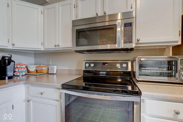 741 Chestnut Ln, Brownsburg, IN 46112 - kitchen featuring stainless steel appliances, light countertops, and white cabinets