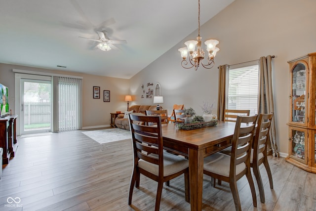741 Chestnut Ln, Brownsburg, IN 46112 - dining area with lofted ceiling, a ceiling fan, light wood-style flooring, and a chandelier