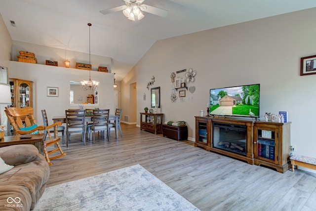 741 Chestnut Ln, Brownsburg, IN 46112 - living room featuring a chandelier, wood finished floors, a ceiling fan, and high vaulted ceiling