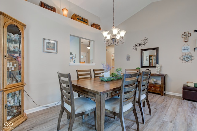 741 Chestnut Ln, Brownsburg, IN 46112 - dining area with light wood finished floors, a chandelier, and high vaulted ceiling