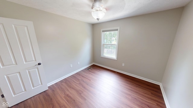9831 Deering St, Fishers, IN 46037 - spare room featuring wood finished floors and a textured ceiling