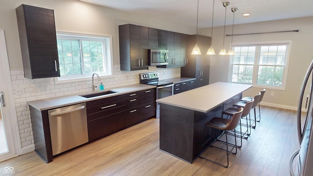9831 Deering St, Fishers, IN 46037 - kitchen featuring appliances with stainless steel finishes, a kitchen breakfast bar, light countertops, plenty of natural light, and recessed lighting