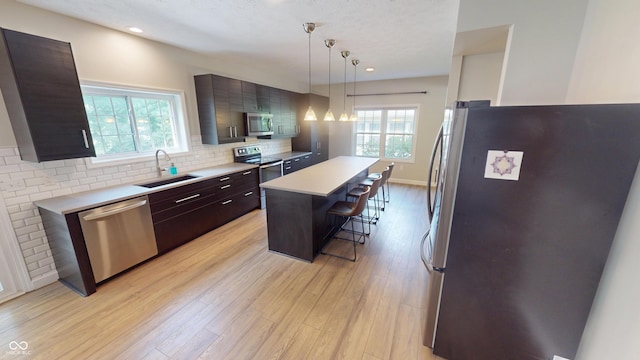 9831 Deering St, Fishers, IN 46037 - kitchen featuring stainless steel appliances, a kitchen breakfast bar, light countertops, plenty of natural light, and recessed lighting
