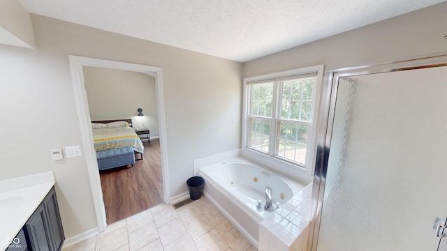 9831 Deering St, Fishers, IN 46037 - bathroom featuring a whirlpool tub, vanity, ensuite bathroom, a stall shower, and tile patterned flooring
